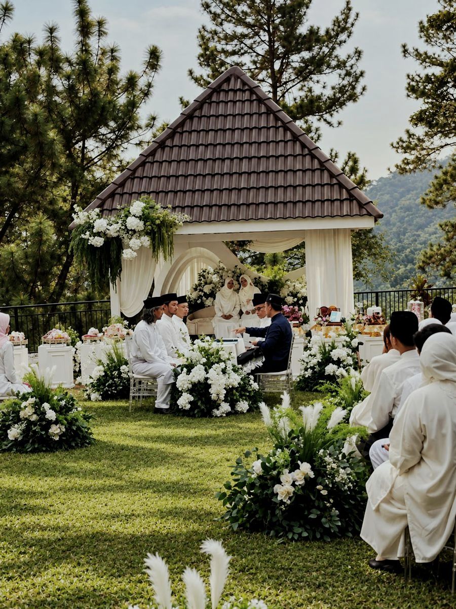 Akad nikah ceremony in the white garden gazebo, guests seated on the lawn